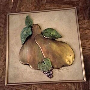 framed metallic fruit art on tile